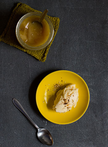 Honig-Eis auf gelbem Teller, daneben ein Glas Honig, Vogelperspektive